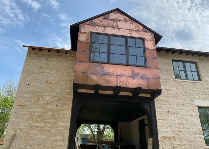 Copper metal panel facade on a stone building for Roof Repair in Perkasie